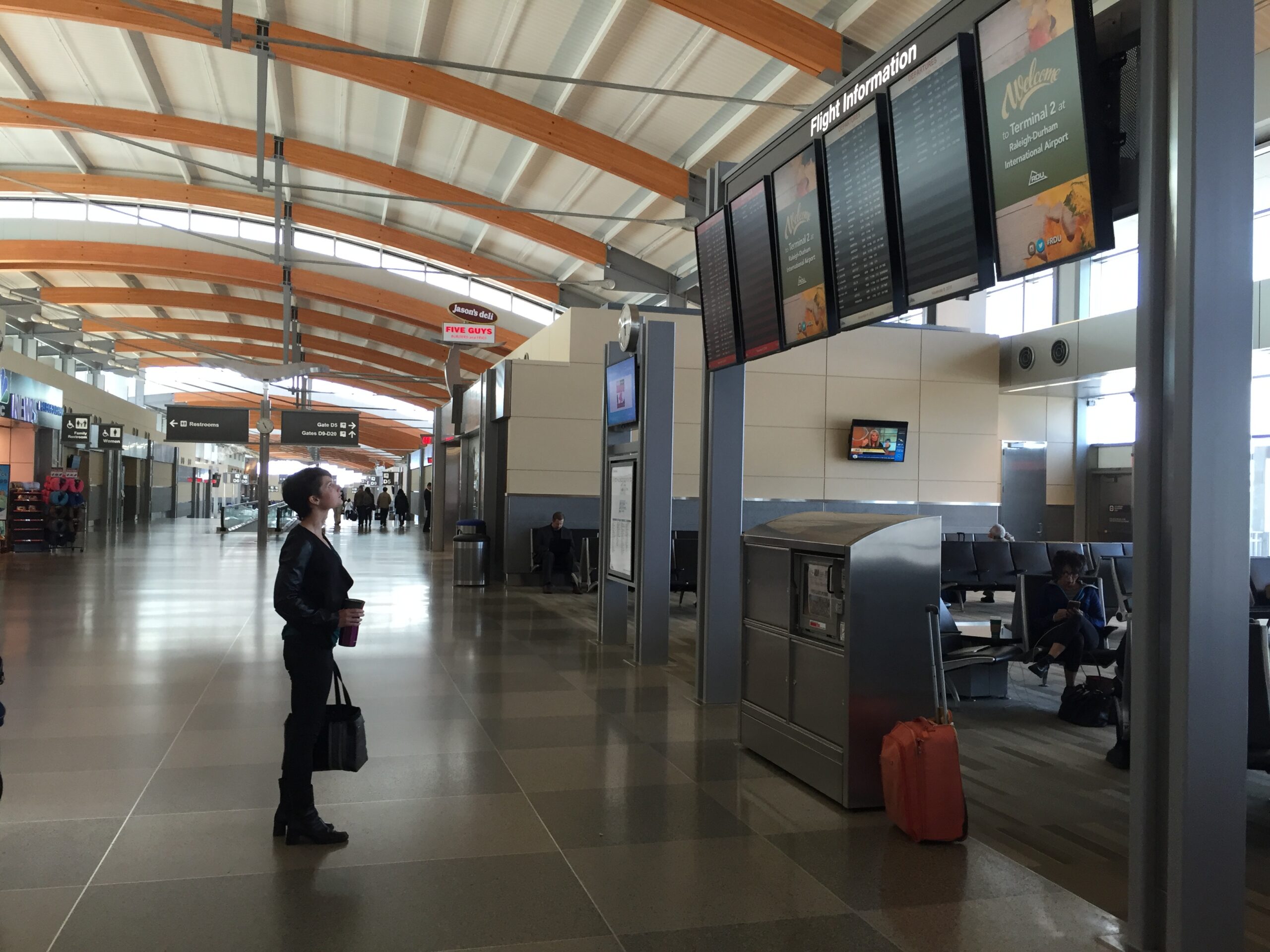 Marcey looking at airport monitor