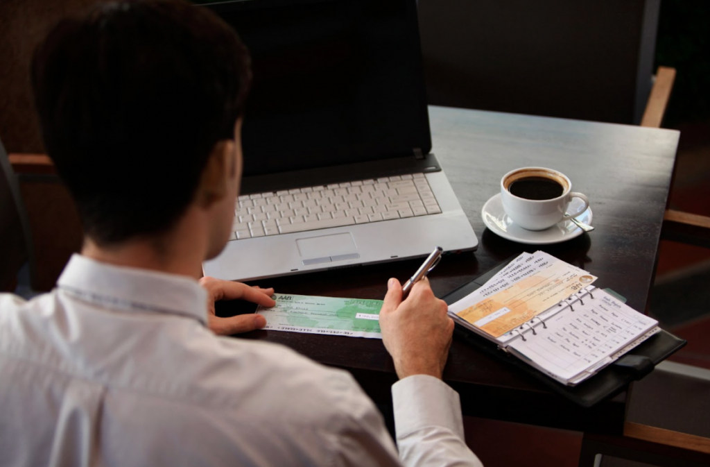 man writing cheque